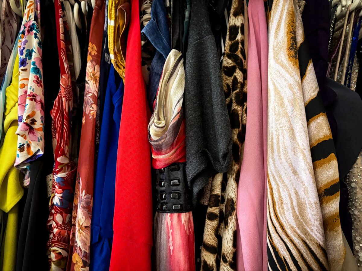 A vibrant collection of vintage clothes on hangers showcasing various patterns and fabrics.